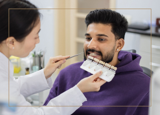 dentist showing dental veneers to patient