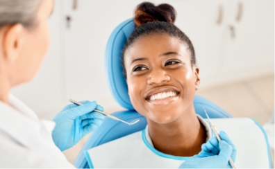 Woman smiling during dental exam procedure at Church Street Dental Care Toronto