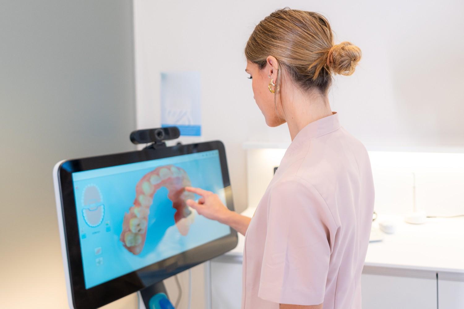 Dentist reviewing digital teeth scan in Toronto