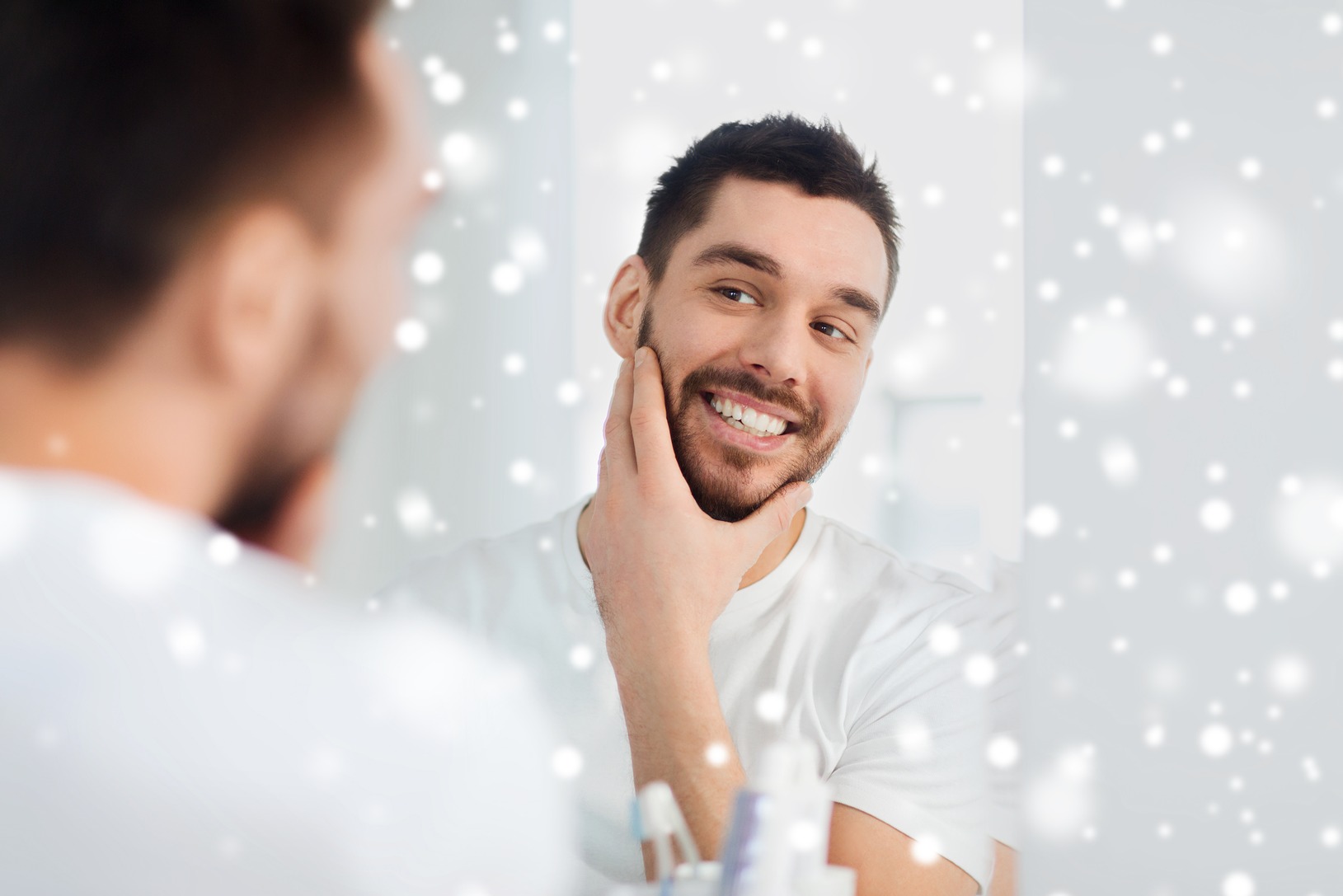 beauty-hygiene-shaving-people-concept-smiling-young-man-looking-mirror-home-bathroom-snow